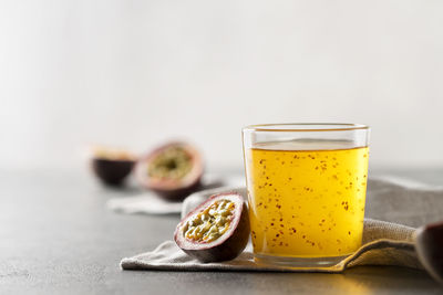 Passion fruit drink with chia seeds in a glass glass.