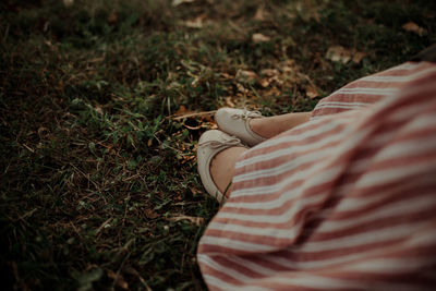 Low section of woman sitting on grass