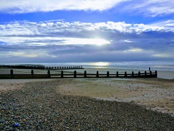 Pier over sea against sky