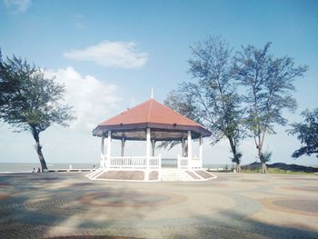 Gazebo by street by building against sky