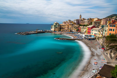 Scenic view of sea and buildings against sky