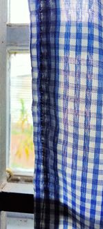 Close-up of curtain against window at home
