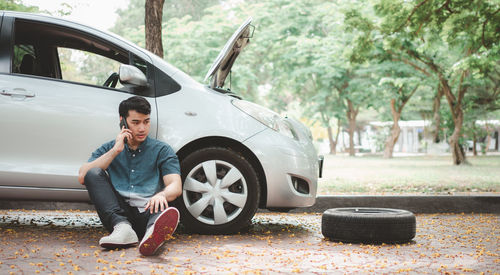 Young man sitting in car