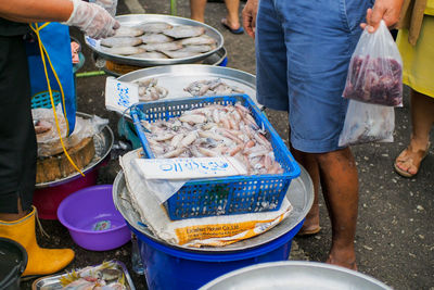 Low section of people at market stall in city