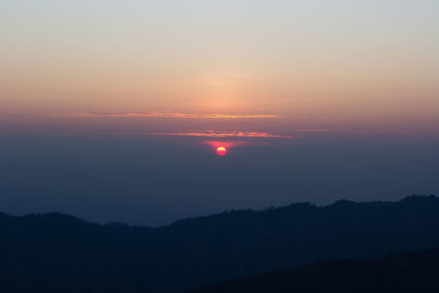 Scenic view of silhouette mountain against romantic sky at sunset