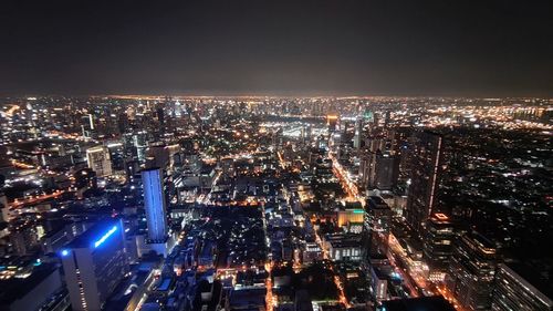 High angle view of illuminated city buildings at night