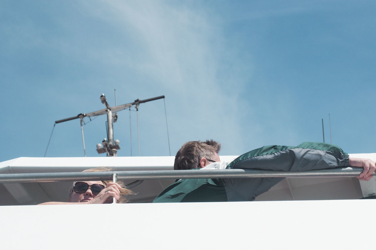 LOW ANGLE VIEW OF PEOPLE ON BOAT