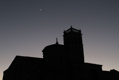 Low angle view of silhouette built structure against sky