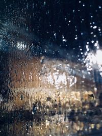 Full frame shot of wet glass window during rainy season