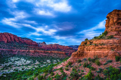 View of rock formations against cloudy sky