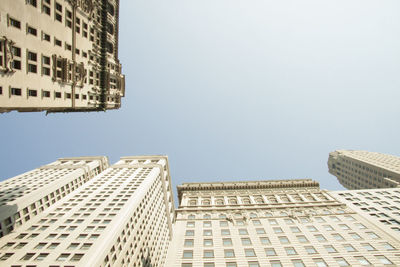 Low angle view of modern buildings against clear sky