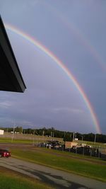 Scenic view of rainbow over field against sky