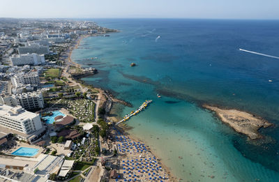 High angle view of sea and buildings against sky