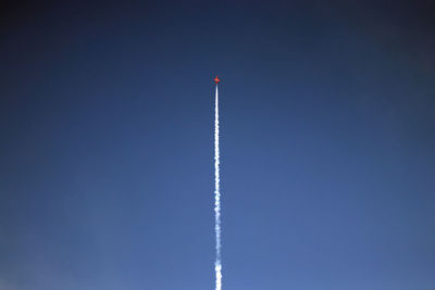 Low angle view of vapor trail against blue sky