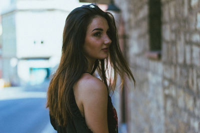 Portrait of beautiful young woman standing outdoors