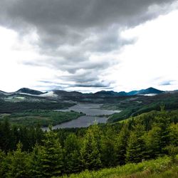 Scenic view of mountains against cloudy sky