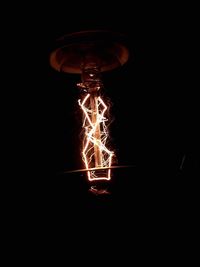 Low angle view of lit lamp post at night