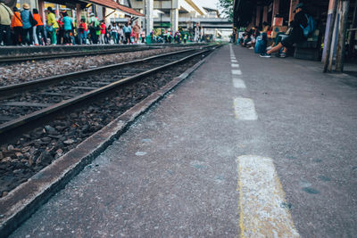 Group of people waiting at railroad station platform