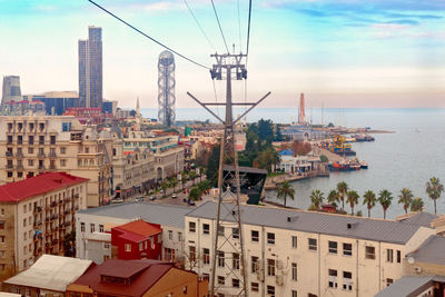 High angle view of buildings by sea against sky