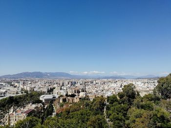 View of townscape against clear blue sky