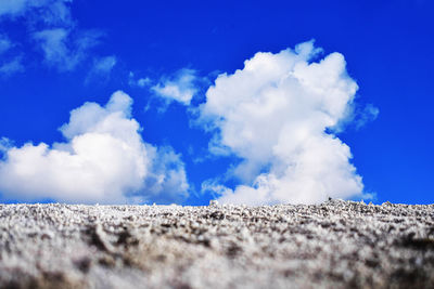 Low angle view of rocks against blue sky