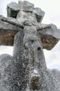 Low angle view of cross on rock