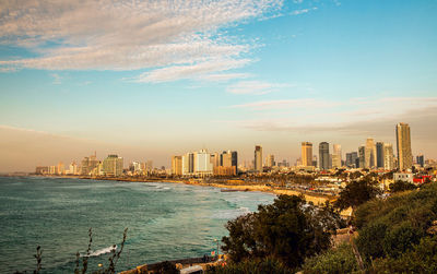 Scenic view of sea and buildings against sky