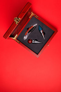 High angle view of telephone booth on table against red background