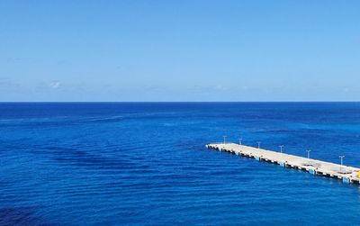 Scenic view of sea against blue sky