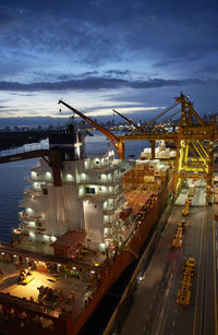 High angle view of illuminated commercial dock against sky