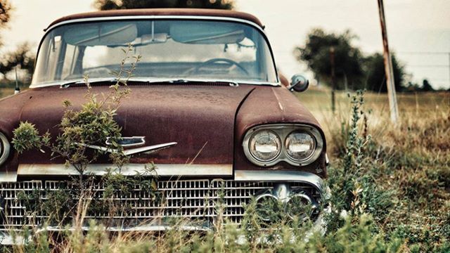 transportation, land vehicle, mode of transport, car, stationary, grass, field, day, travel, focus on foreground, outdoors, plant, part of, sky, no people, on the move, street, close-up, bicycle, tree