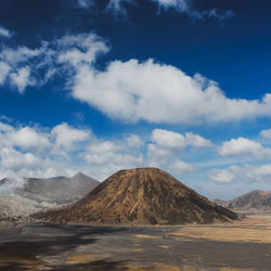 View of volcanic landscape against cloudy sky