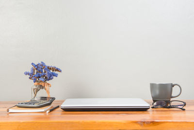 Electric lamp on table against wall at home