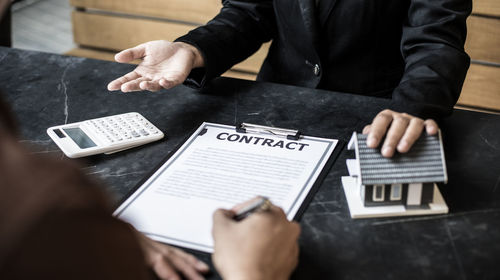 High angle view of man using smart phone on table