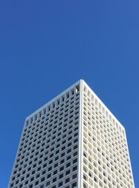 Low angle view of modern building against clear blue sky