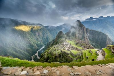 Panoramic view of mountains against cloudy sky