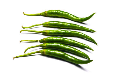 Close-up of green chili pepper against white background