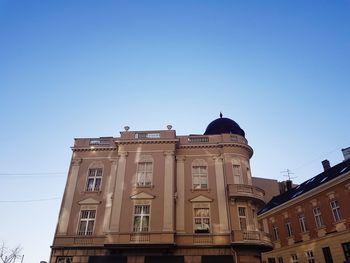 Low angle view of building against clear blue sky