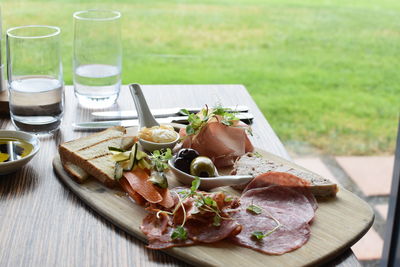 Food on cutting board over table