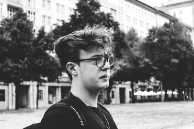Portrait of young man looking away outdoors