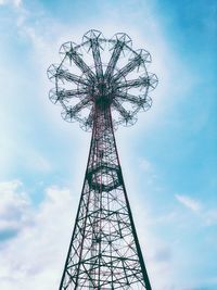 Low angle view of ferris wheel against cloudy sky
