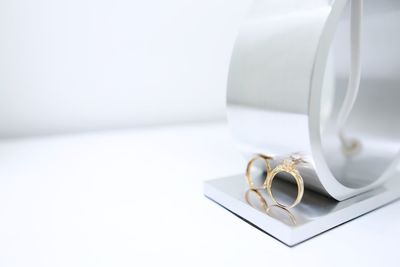 Close-up of wedding rings on table