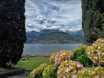 Scenic view of sea and mountains against sky