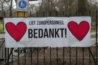 Close-up of text on heart shape sign