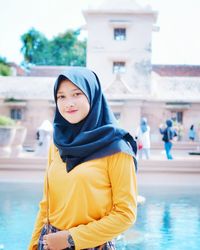Portrait of woman standing in swimming pool