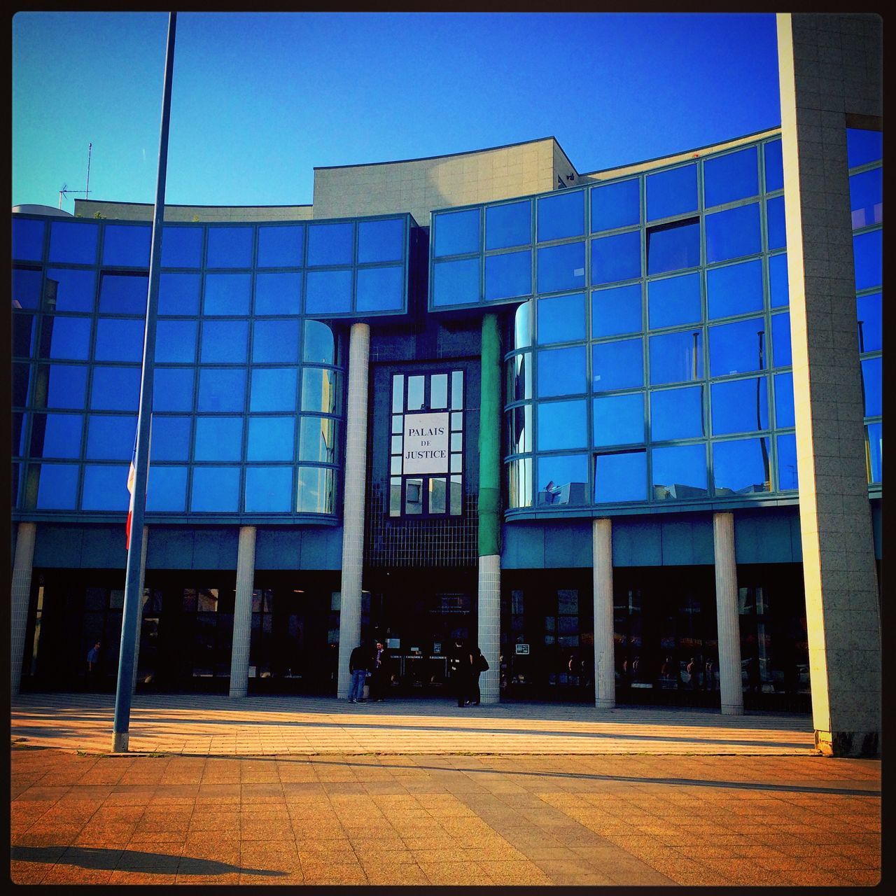 architecture, built structure, building exterior, window, transfer print, blue, glass - material, city, building, auto post production filter, sunlight, clear sky, day, sky, reflection, residential building, low angle view, exterior, outdoors, facade