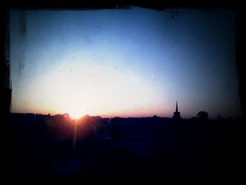 Silhouette of built structure at sunset