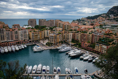 High angle view of buildings by sea against sky