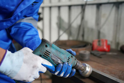 Midsection of man working in workshop