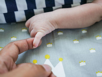 Low section of child holding hands
